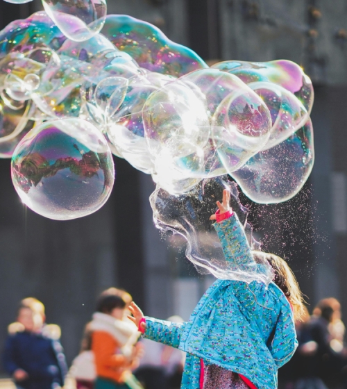 image of a toddler enjoying bubbles 